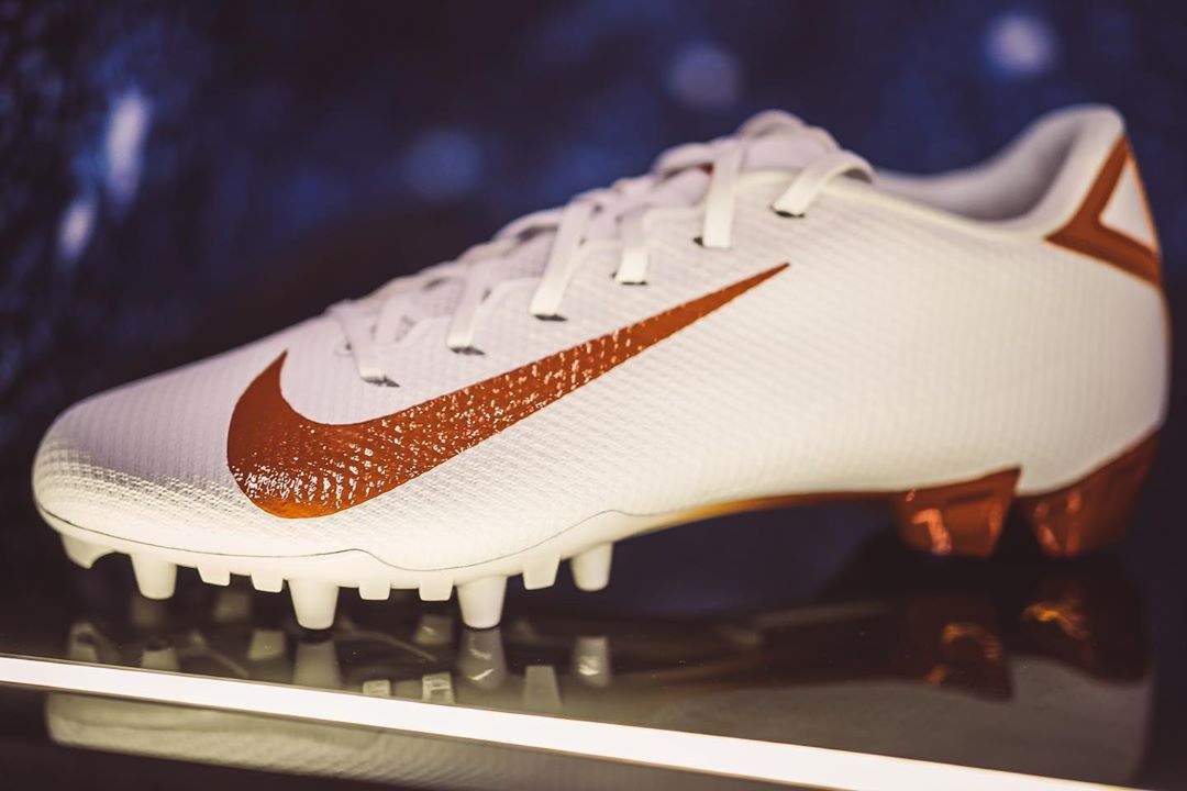 orange and white football cleats